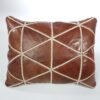 a brown leather pillow with white stitching