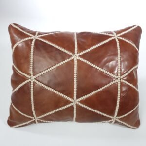 a brown leather pillow with white stitching